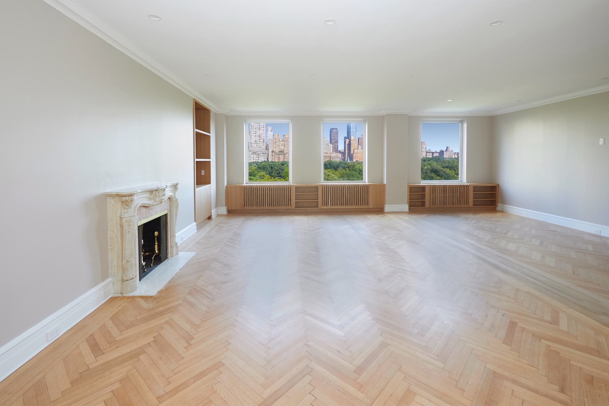 817 Fifth Avenue — living room with herringbone floors, marble mantel and Central Park views