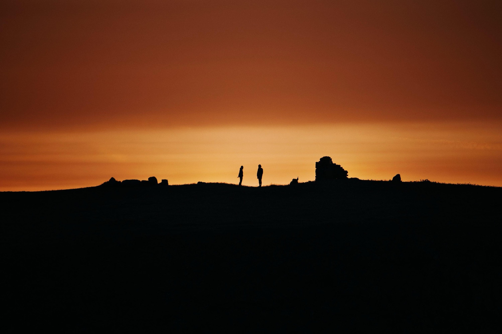 Two figures together at sunset