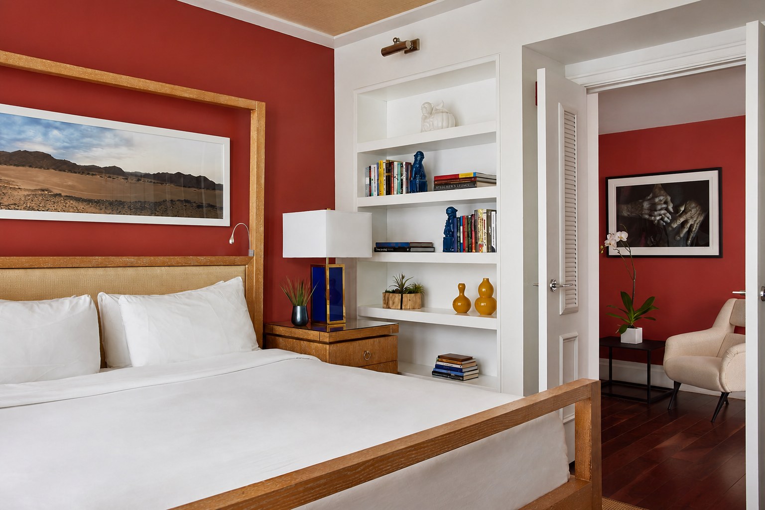 The Carlton Hotel — a balcony suite bedroom with a terracotta wall and built-in shelving
