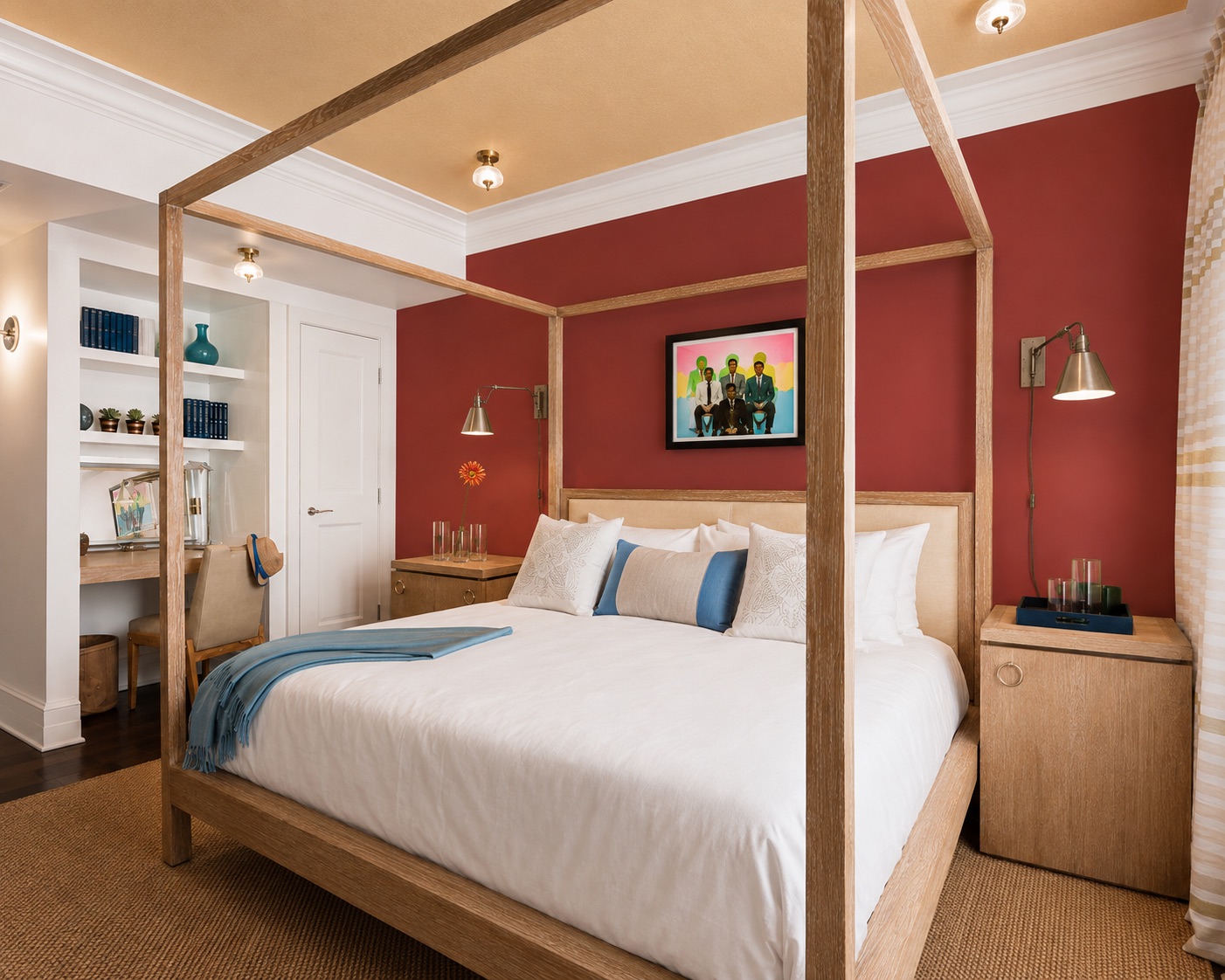 The Carlton Hotel — a room with a light-wood four-poster canopy bed against a deep red wall