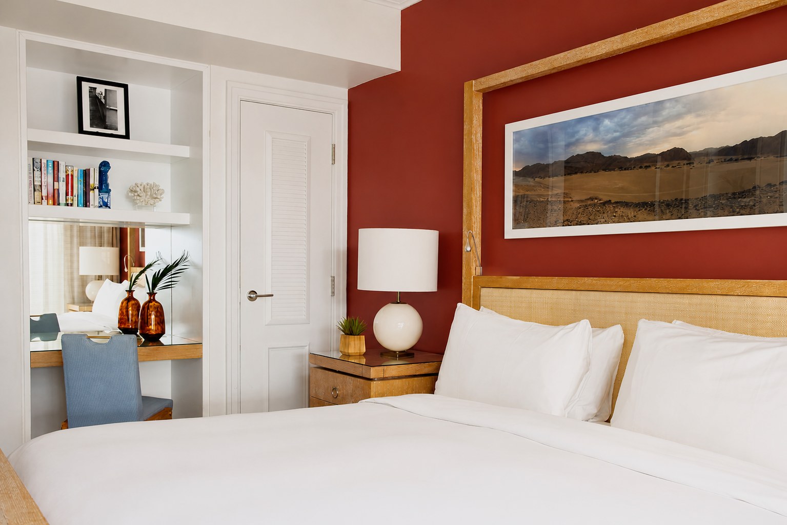 The Carlton Hotel — a Classic King room with a terracotta accent wall and cane headboard