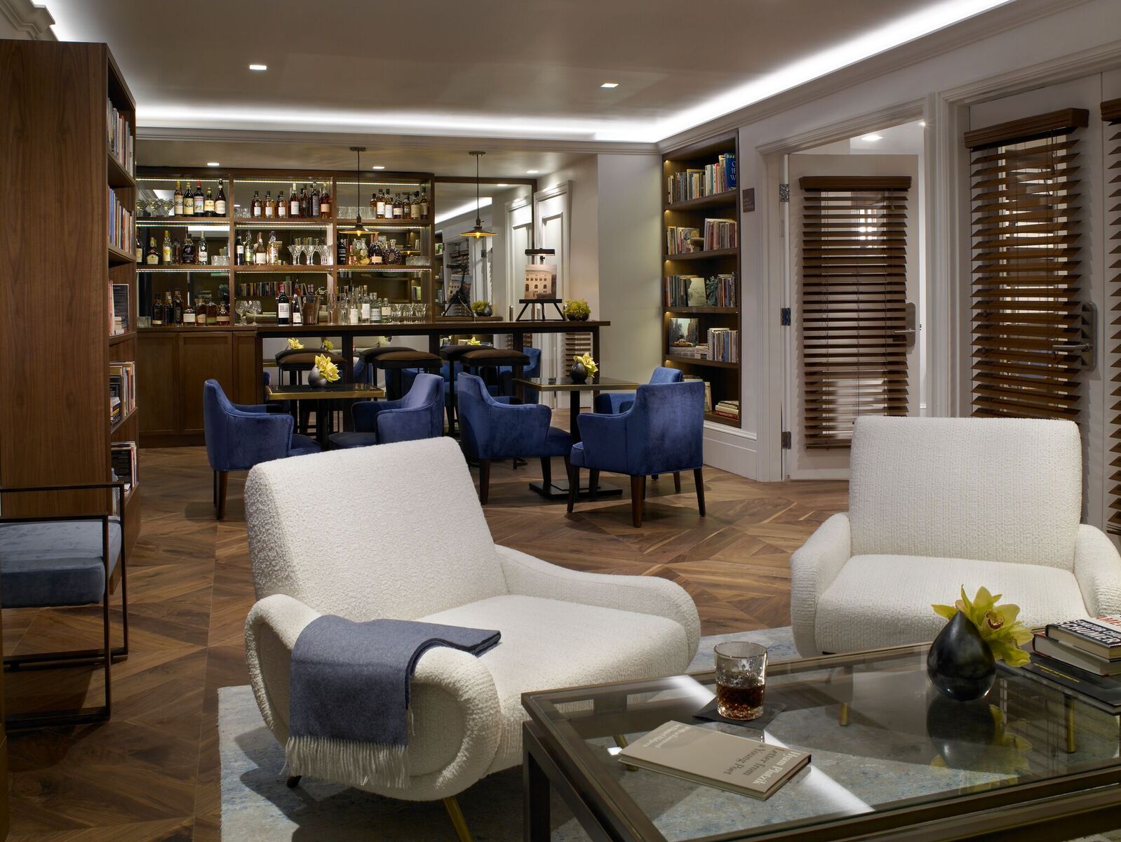 The Carlton Hotel — the library and cocktail lounge, with a walnut back-bar and blue velvet chairs