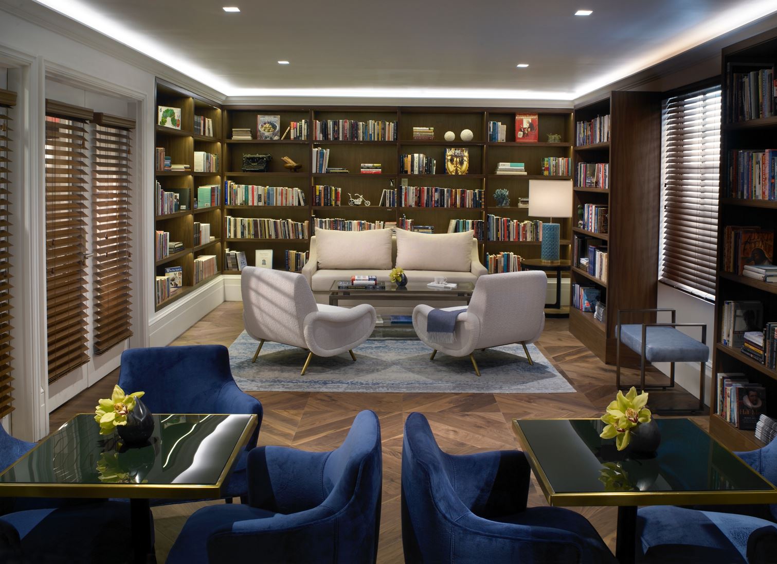 The Carlton Hotel — the library lounge, with walnut bookshelves and blue velvet seating