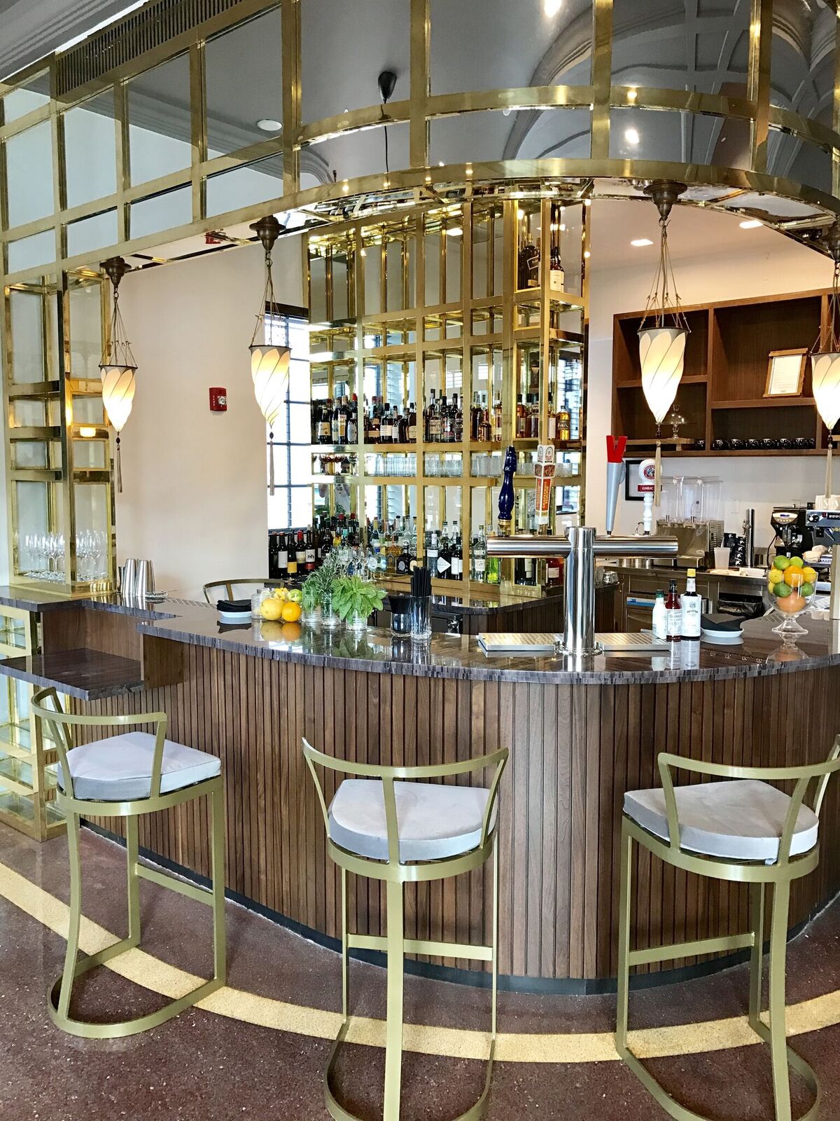 The Carlton Hotel — the circular brass bar with a coffered ceiling and terrazzo floor