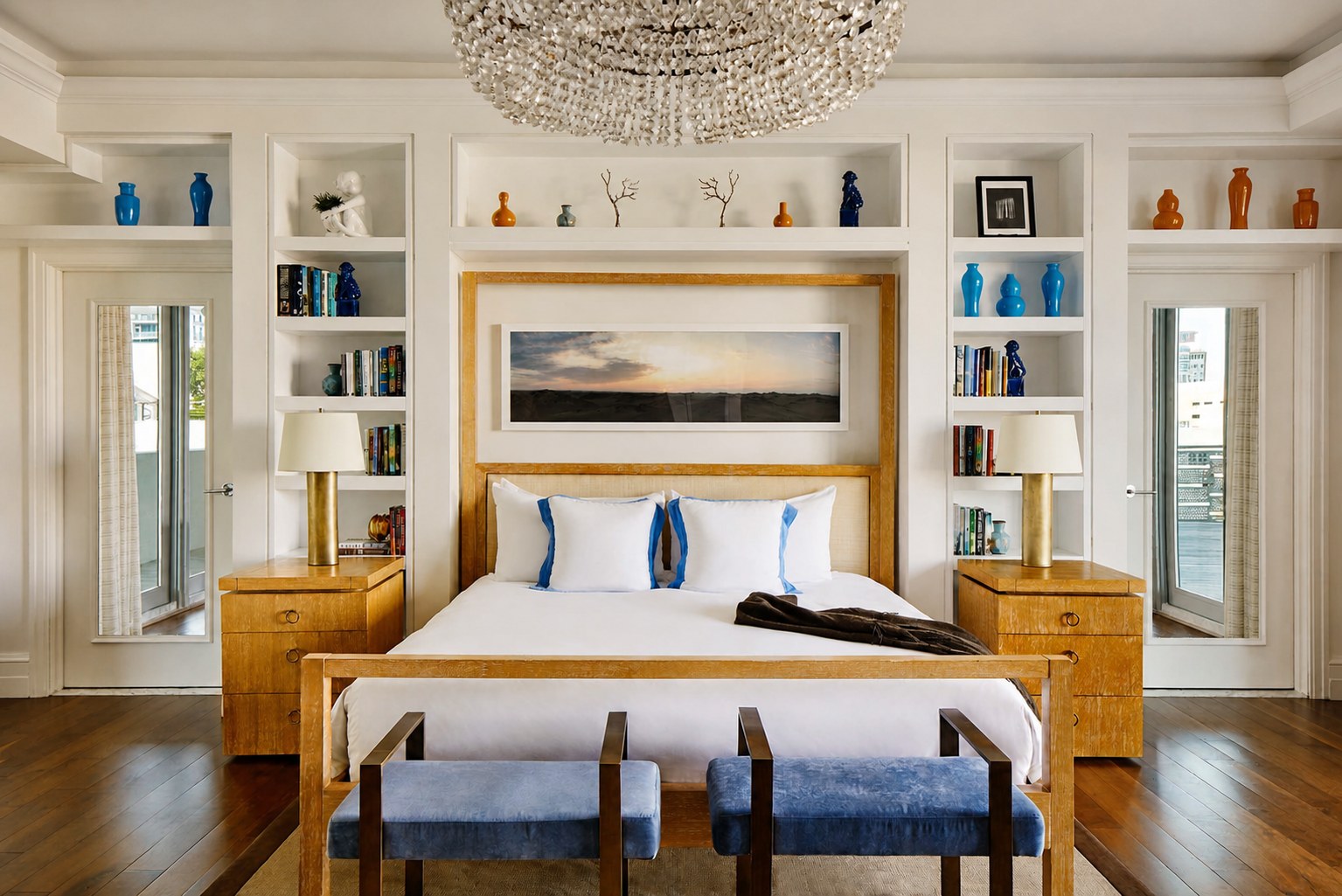 The Carlton Hotel — the Skyline Penthouse bedroom, with a crystal chandelier and flanking built-ins
