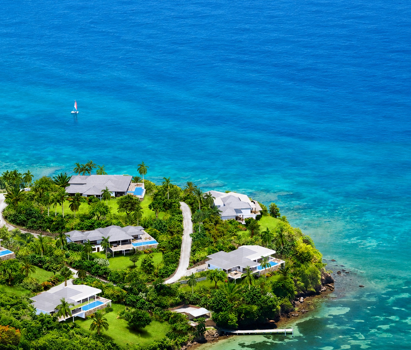 Laluna Ville — aerial view of the villa on its headland above the Caribbean