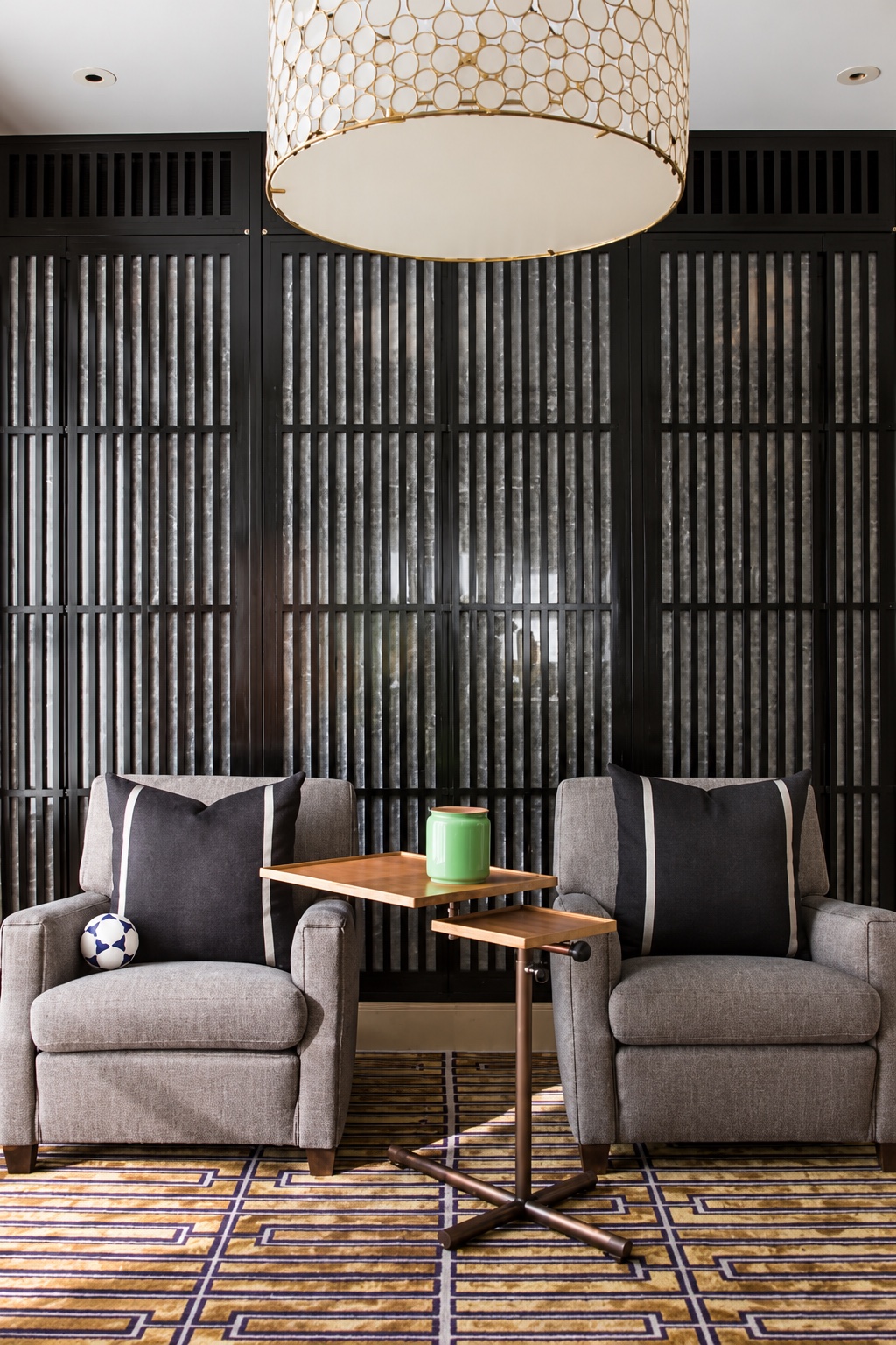 Tribeca Loft — paired armchairs against a dark slatted wall