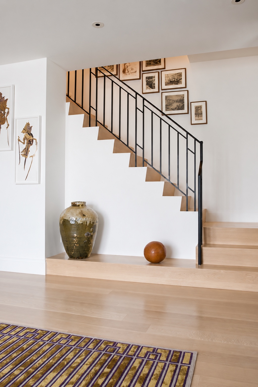 Tribeca Loft — staircase with iron railing and framed gallery wall